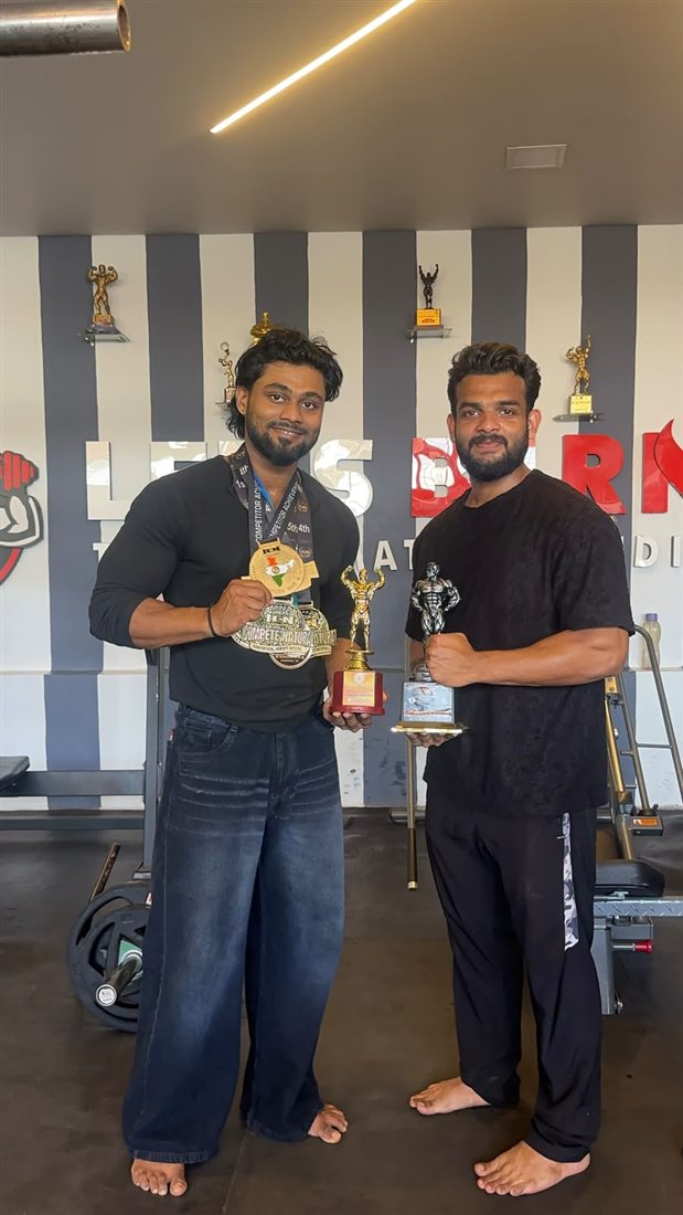 Anoop with his ICN medals and trophy, with his coach, at the Let's Burn gym